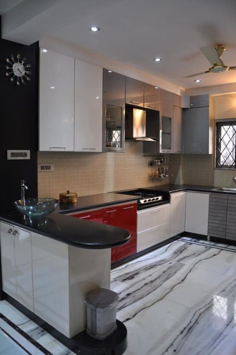 U shaped kitchen with modern cabinets and wall decor by Prashant Mali.jpg