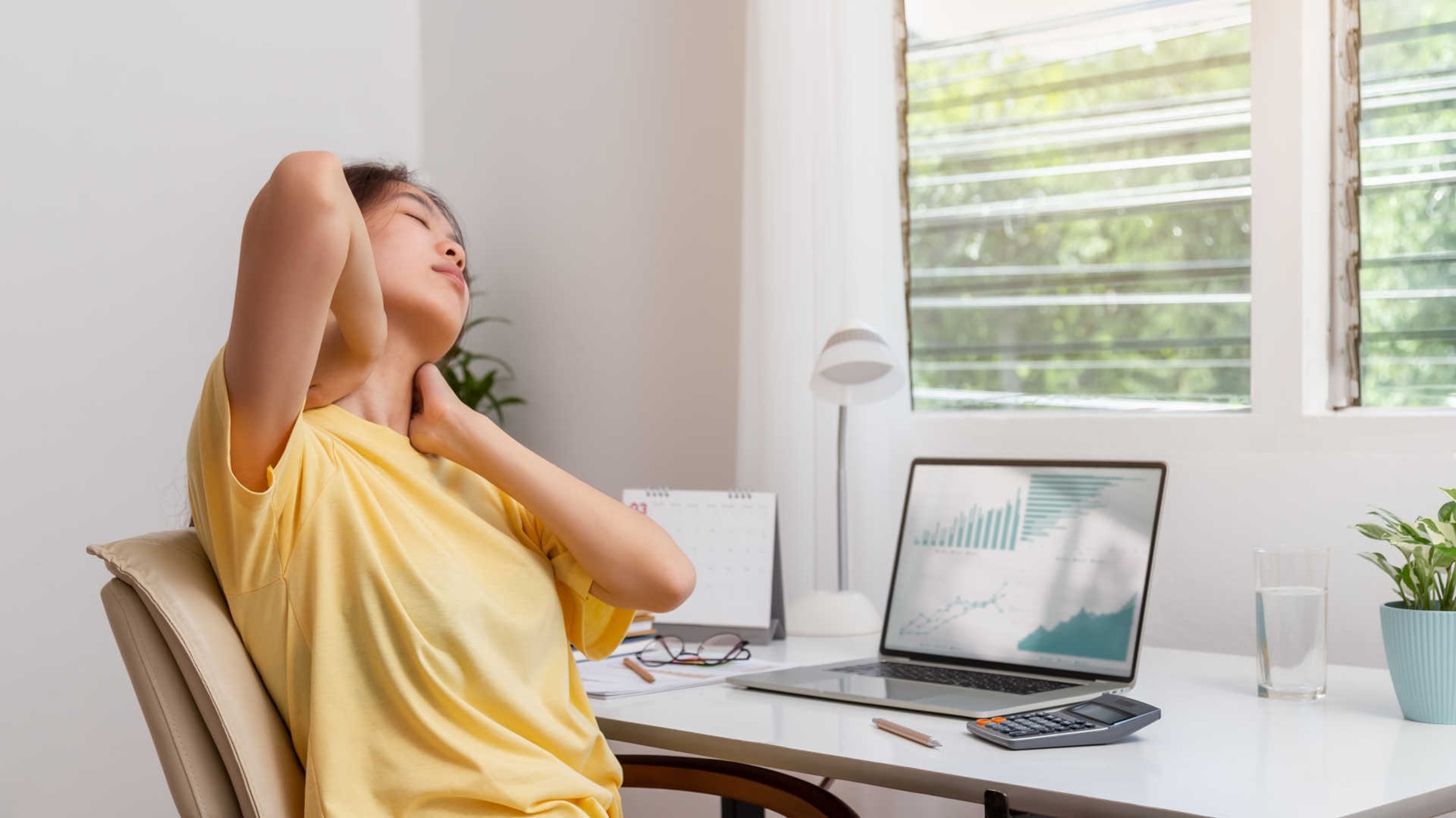 A woman is experiencing chronic neck pain caused by not using ergonomic chairs.